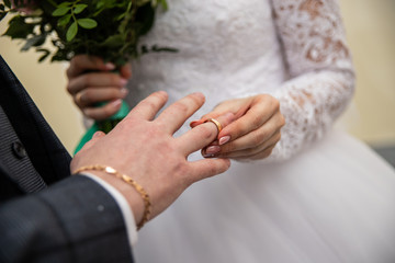 the bride wears a ring to the groom