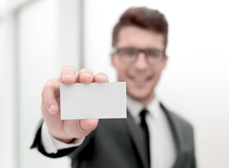 close up.successful businessman showing his business card