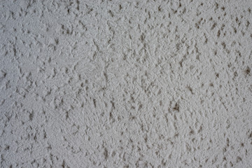 Graue Wand mit Rohputz