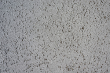 Graue Wand mit Rohputz