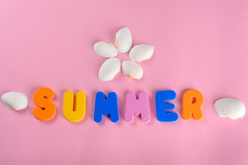 Word SUMMER letters and seashell or sea shell on pink textured background. Original idea from natural material for summer design. Flat lay.