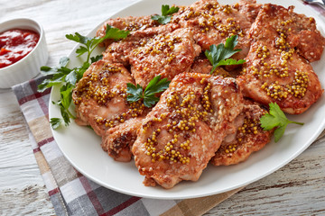 juicy chicken steaks on a white plate