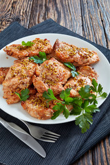 juicy chicken steaks on a white plate