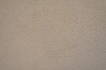 Feine Wand mit Creme-Farbe gestrichen und kontrastarm