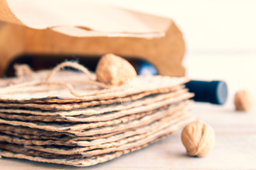 Passover grocery shopping composition with a matzah or matza and red kosher wine in a shopping bag.
