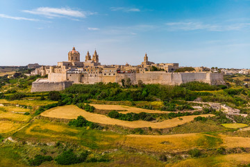 Fototapeta na wymiar Aerial view Of Mdina City. Old Capital Of Malta Country. Blue sky and green yellow fields