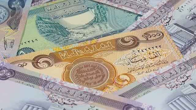 Iraq currency dinar notes rotating. Iraqi money. Low angle. Stock video footage