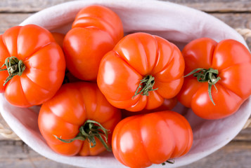 Natural fresh tomatoes on the wood.
