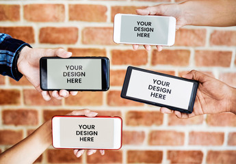 Four Hands Holding Smartphones in front of Wall Mockup
