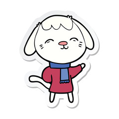 sticker of a happy cartoon dog in winter clothes