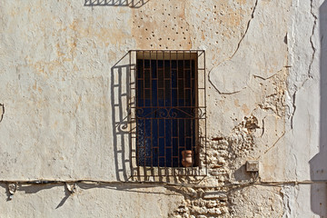 Fototapeta na wymiar Window on aged building facade with ancient look