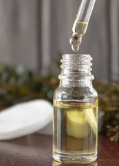 Face oil in a glass bottle on a dark background.