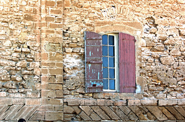 Window on aged building facade with ancient look
