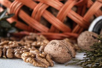 Walnuts on a white background near the basket.