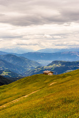 Obraz premium Alpe di Siusi, Seiser Alm with Sassolungo Langkofel Dolomite, a large green field with a mountain in the background