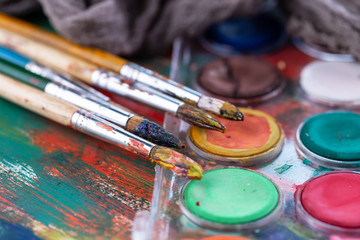 Paint brushes and paints for drawing.