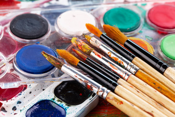Paint brushes and paints for drawing.
