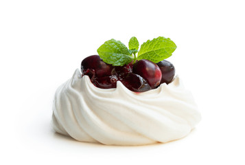 Mini Pavlova meringue nest with cranberry and mint leaves isolated on white