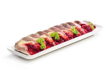 Herring slices stuffed with beetroot and potato arranged in a serving dish