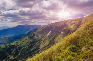 dramatic sunset over the mountain top. cloudy pink sky before twilight.