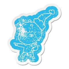 cartoon distressed sticker of a amazed boy wearing santa hat