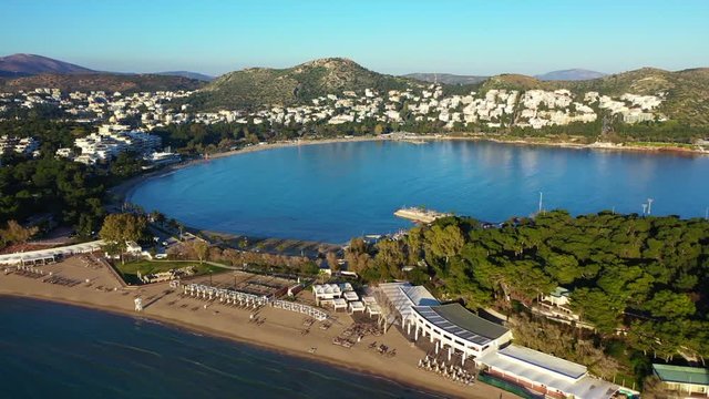 Aerial drone video of iconic turquoise sandy celebrity beach of Asteras or Astir and ancient temple of Apollo Zoster, Vouliagmeni, Athens riviera, Attica, Greece