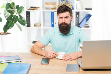 corporate party. Businessman in gold crown. corporate man drink coffee. Boss workplace. Bearded man...