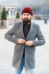 Buttoning his jacket. Hipster outfit and hat accessory. Stylish casual outfit spring season....