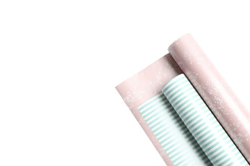 Rolls of festive wrapping paper on white background. Space for text