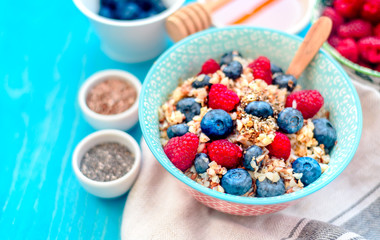 High protein healthy breakfast, buckwheat porridge with blueberries, raspberries, flax seeds and honey Closeup view, selective focus