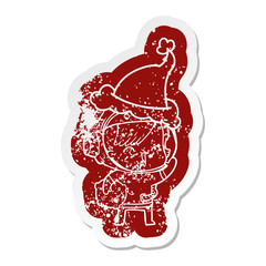 cartoon distressed sticker of a happy spacegirl holding moon rock wearing santa hat