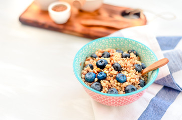 High protein healthy breakfast, buckwheat porridge with blueberries, flax seeds and honey