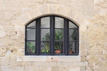 Fototapeta na wymiar Old window in stone wall