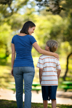 Mother and son walking in the park.