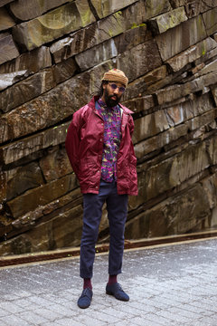 Portrait of adult by rock wall
