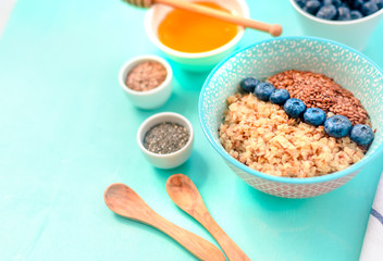 Buckwheat porridge in a bowl with flax seeds and blueberries. oncept healthy food, detox, diet, breakfast