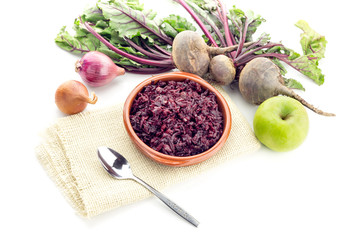 Fresh, stewed beetroot caviar with spice, onions and an apple on a white background