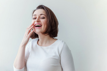 Happy girl smiling. Beauty portrait young happy positive laughing brunette woman on white...