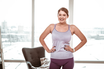 Smiling resolute young woman wearing comfortable light clothes