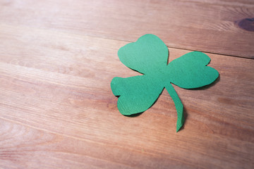 Green clover leaf on wooden table