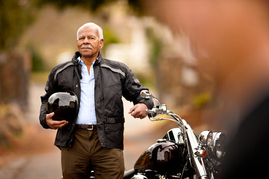 Portrait of a senior man and his motorcycle. 