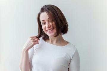 Happy girl smiling. Beauty portrait young happy positive laughing brunette woman on white...