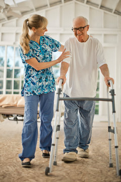 Happy senior man smiling at his nurse.