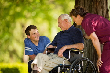 Happy teenage boy talking with his grandfather.