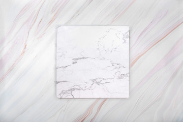 Flat lay of white blank marble card on marble background with natural texture