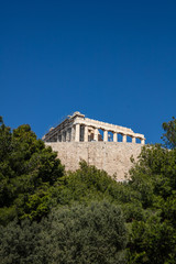 Fototapeta na wymiar Acropolis of Athens Greece rock and Parthenon on blue sky background, sunny day.