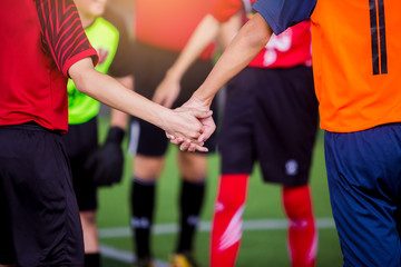 Fototapeta premium boy soccer players tap hands together for football training