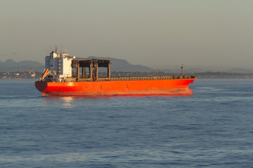 Giant general cargo ship with big gantry cranes at anchorage