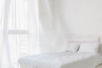 Abstract white bedroom interior. Total white bedroom with window with flying curtains. Morning...