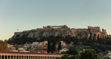 Fototapeta na wymiar Acropolis of Athens Greece rock and Parthenon on blue sky background in the evening.